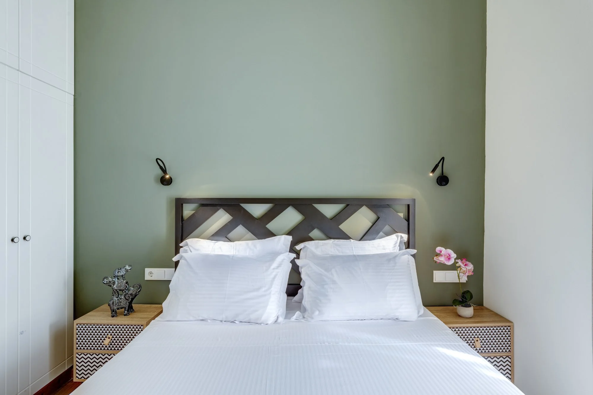 Bedroom one headboard, reading lights and patterned bedside tables