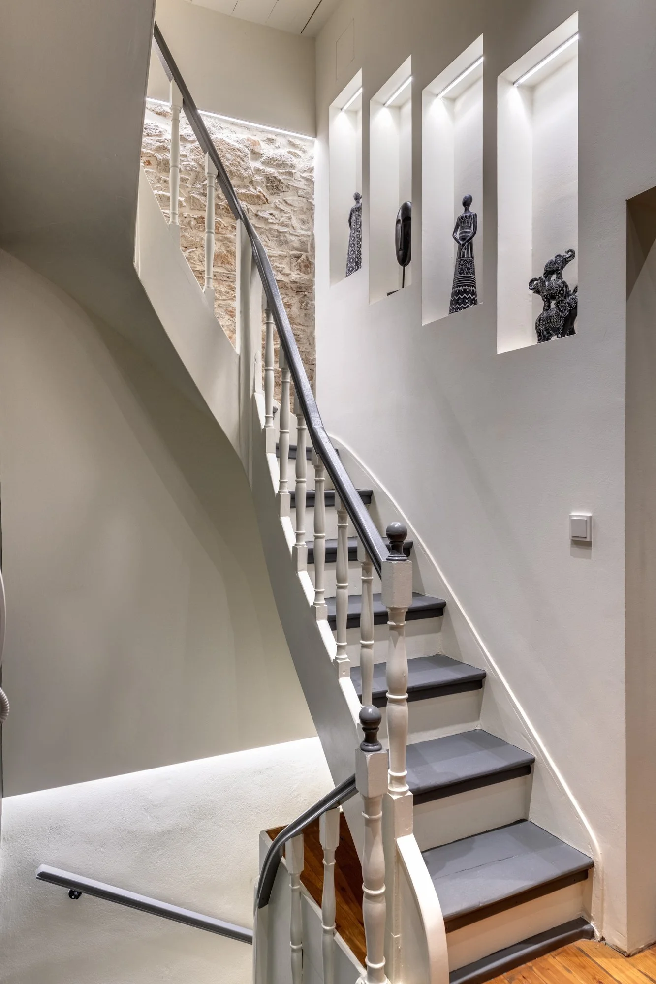 Staircase with timber treads and white wall