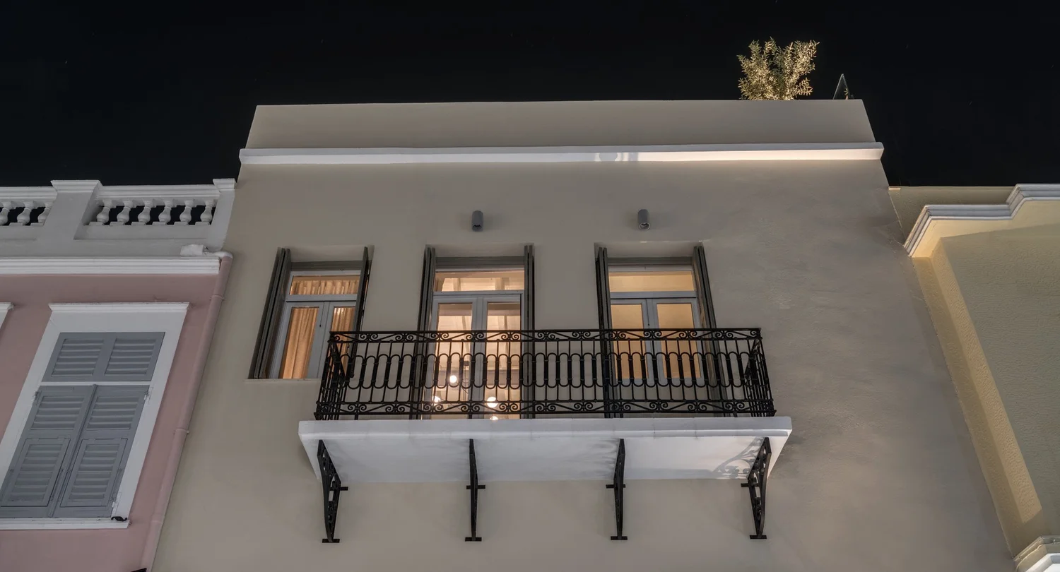 Nighttime facade lit from the street