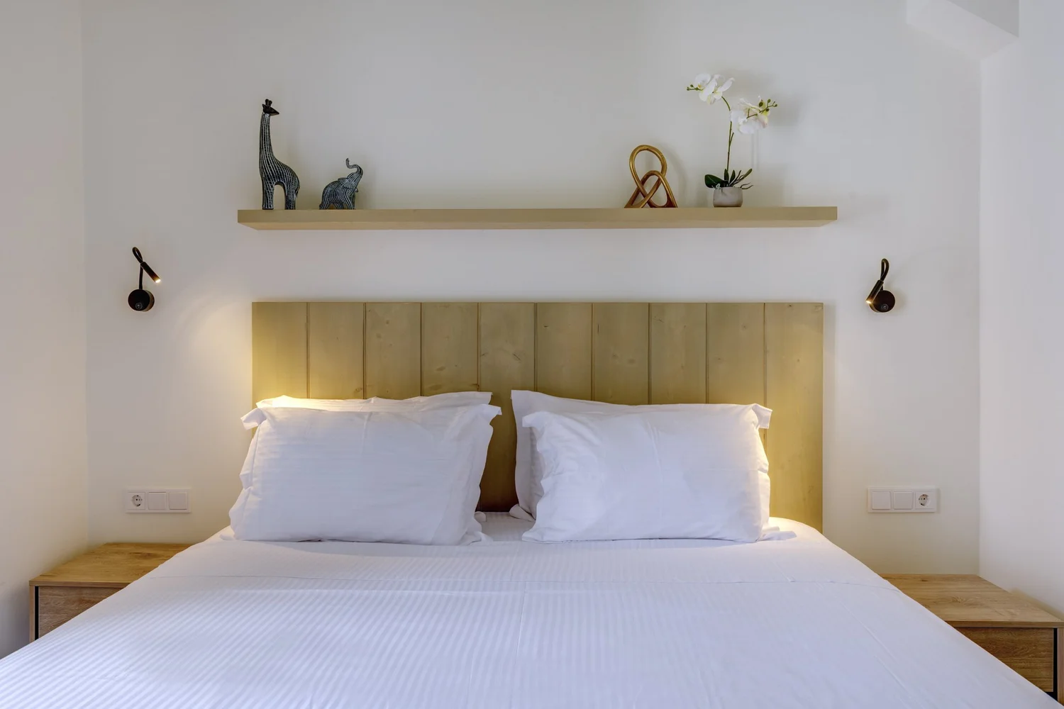 Bedroom two with bedside table and soft neutral styling