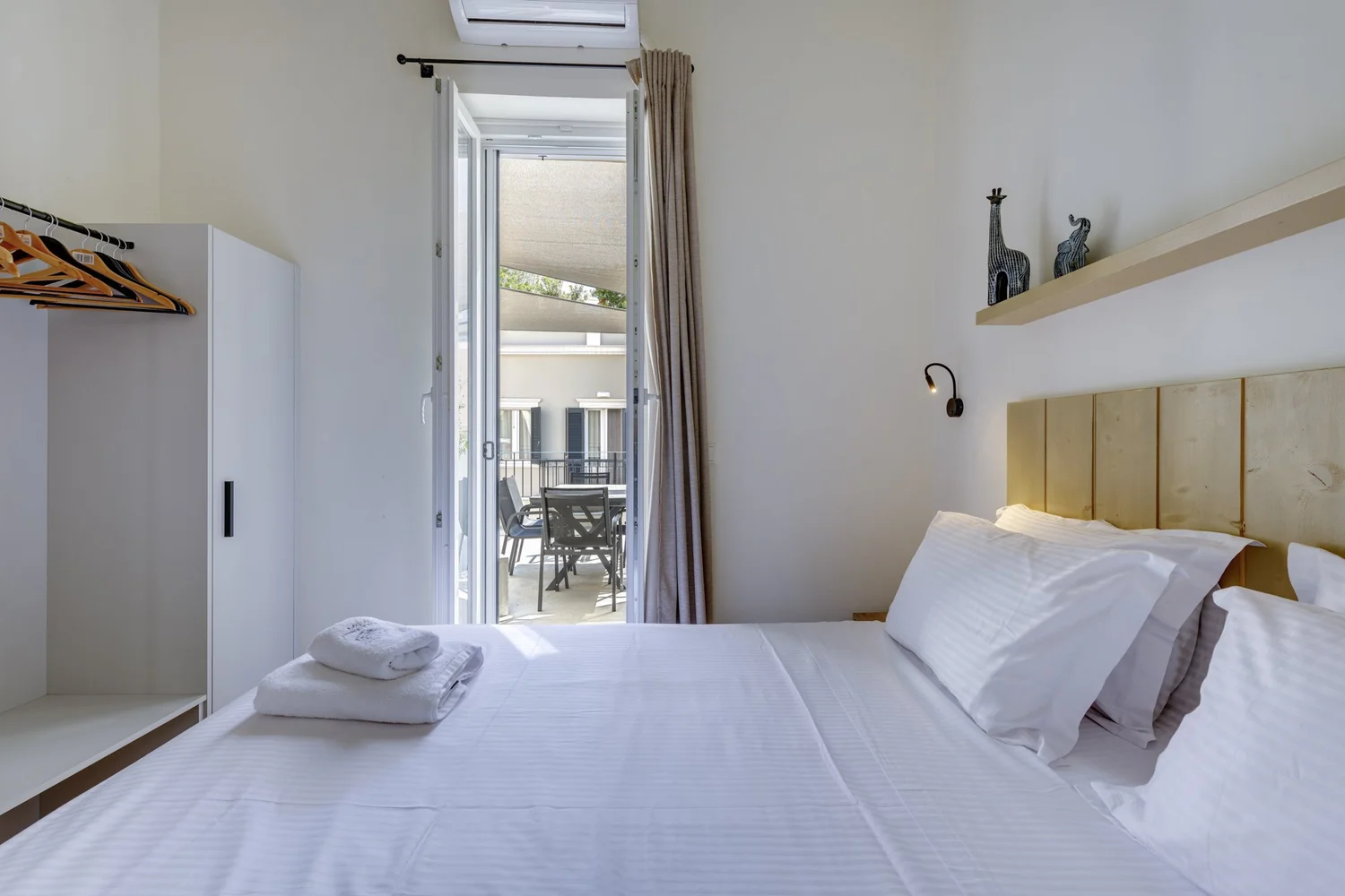 Bedroom two doors opening directly to the lower terrace